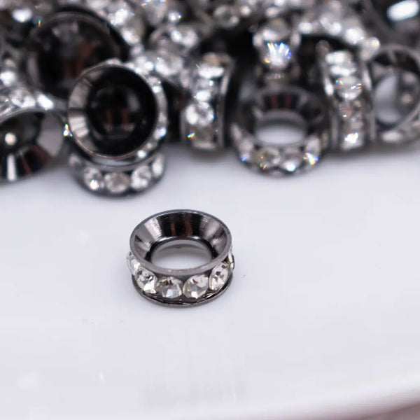 close up view of a pile of 10mm Black Large Hole Rondelle Spacer Beads - Set of 20