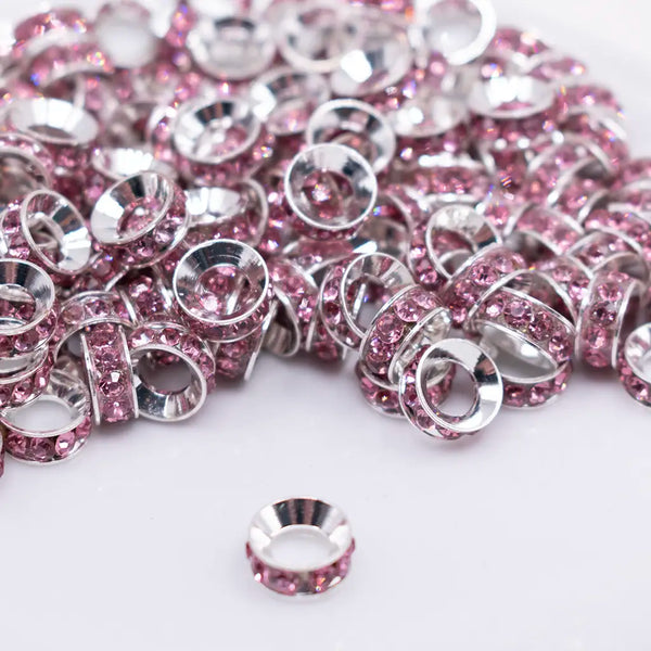 front view of a pile of 10mm Pink Large Hole Rondelle Spacer Beads - Set of 20