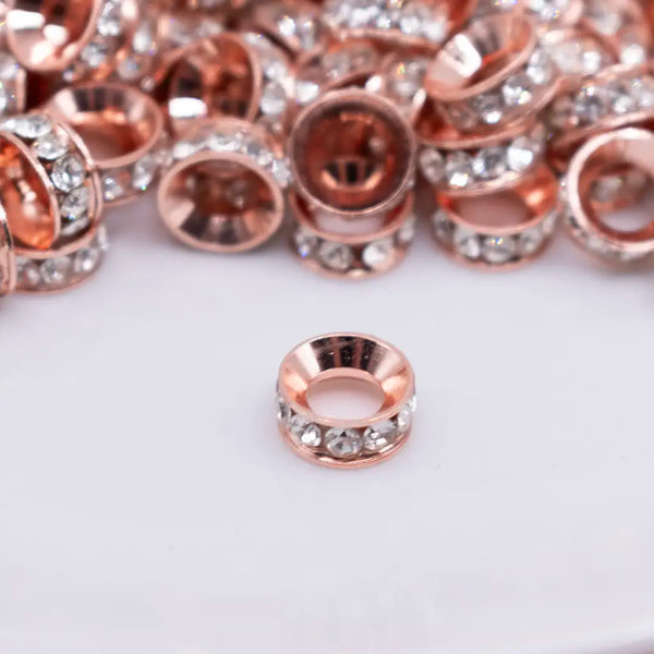 close up view of a pile of 10mm Rose Gold Large Hole Rondelle Spacer Beads - Set of 20