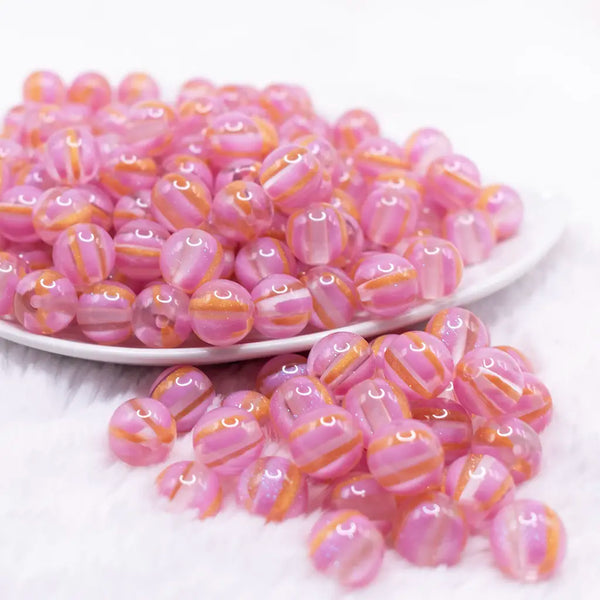 front view of a pile of 12mm Bright Pink Cats Eye Acrylic Bubblegum Beads - 20 Count