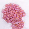 top view of a pile of 12mm Bright Pink Cats Eye Acrylic Bubblegum Beads - 20 Count