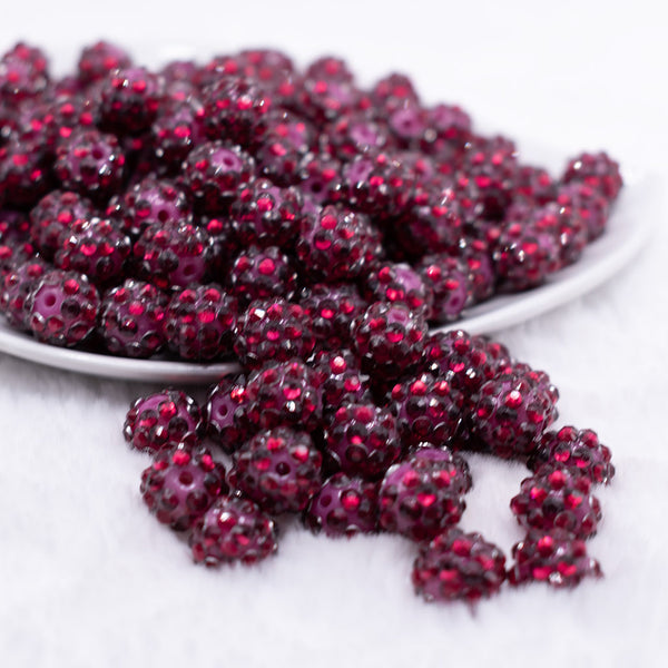 front view of a pile of 12mm Cranberry Red with Clear Rhinestone Bubblegum Beads