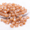 front view of a pile of 12mm Gold Cats Eye Acrylic Bubblegum Beads - 20 Count