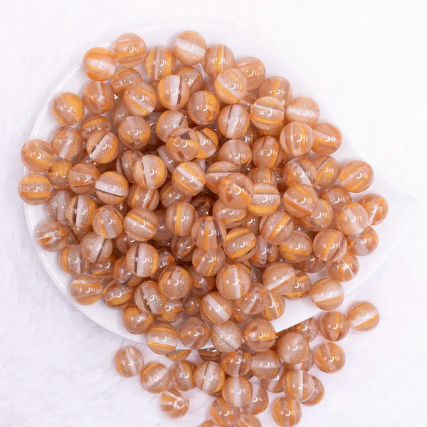 top view of a pile of 12mm Gold Cats Eye Acrylic Bubblegum Beads - 20 Count