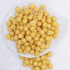 top view of a pile of 12mm Lemon Yellow Rhinestone AB Bubblegum Beads