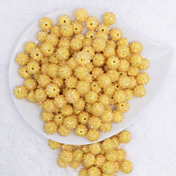top view of a pile of 12mm Lemon Yellow Rhinestone AB Bubblegum Beads