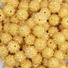 close up view of a pile of 12mm Lemon Yellow Rhinestone AB Bubblegum Beads