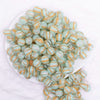 top view of a pile of 12mm Mint Green Cats Eye Acrylic Bubblegum Beads - 20 Count