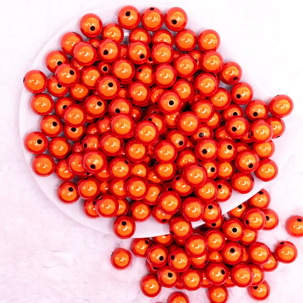 top view of a pile of 12mm Orange Miracle Bubblegum Beadtop view of a pile of 12mm Orange Miracle Bubblegum Bead
