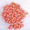 top view of a pile of 12mm Orange with White Stripe Beach Ball Bubblegum Beads