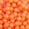 close up view of a pile of 12mm Orange Neon AB Solid Bubblegum Beads