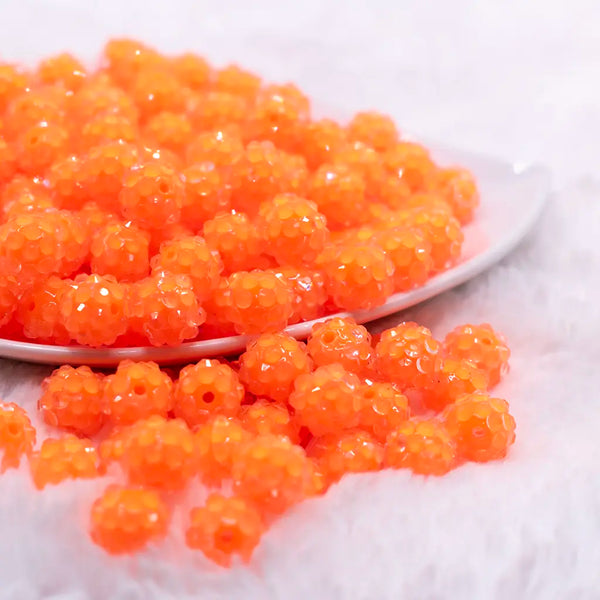 front view of a pile of 12mm Orange Neon Rhinestone Bubblegum Beads