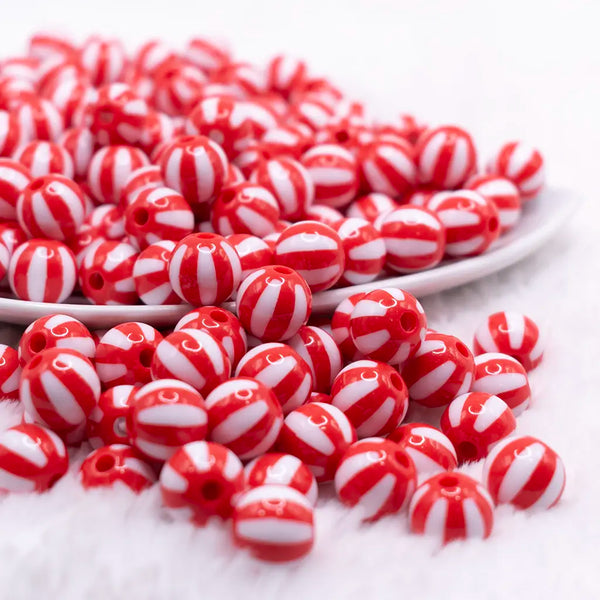 front view of a pile of 12mm Red with White Stripe Beach Ball Bubblegum Beads