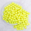 top view of a pile of 12mm Yellow Neon AB Solid Bubblegum Beads