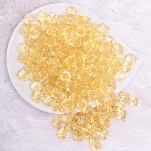 top view of a pile of 12mm Blonde Yellow Transparent Cube Faceted Bubblegum Beads
