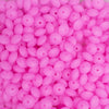 top view of a pile of 12mm Bright Pink Glow in The Dark Lentil Silicone Bead