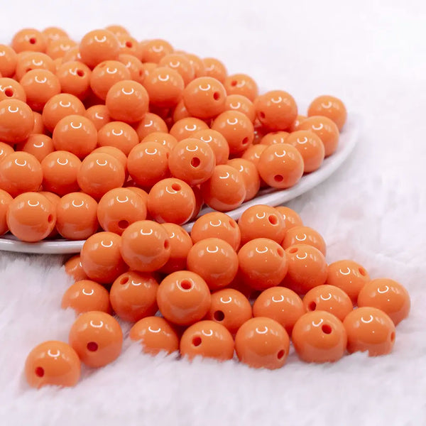 front view of a pile of 12mm Canteloupe Orange Acrylic Bubblegum Beads