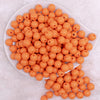 top view of a pile of 12mm Cantaloupe Orange Acrylic Bubblegum Beads