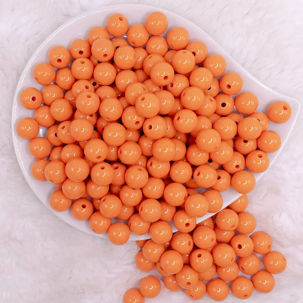 top view of a pile of 12mm Cantaloupe Orange Acrylic Bubblegum Beads