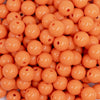 close up view of a pile of 12mm Cantelope Orange Acrylic Bubblegum Beads