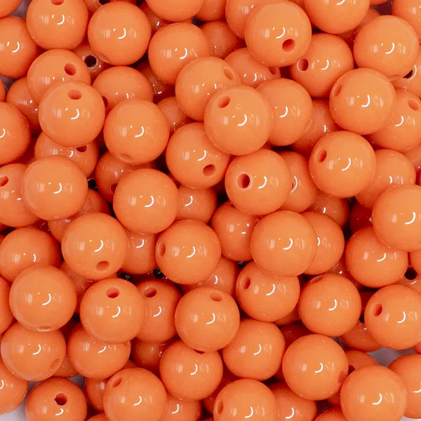 close up view of a pile of 12mm Cantelope Orange Acrylic Bubblegum Beads