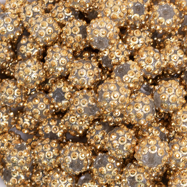 close up view of a pile of 12mm Gold Flower Rhinestone AB Bubblegum Beads