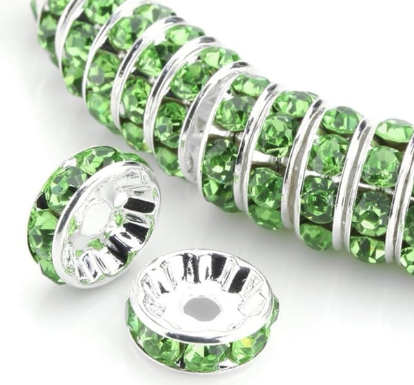 front view of a pile of 12mm Green Rhinestone Rondelle Spacer Beads - Set of 10
