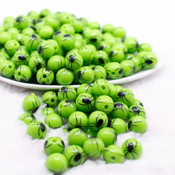 front view of a pile of 12mm Green with Black Spider Print Bubblegum Beads