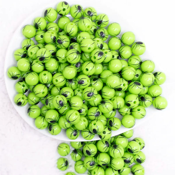 top view of a pile of 12mm Green with Black Spider Print Bubblegum Beads