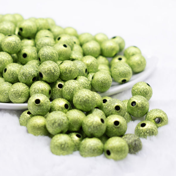 front view of a pile of 12mm Lime Green Stardust Bubblegum Beads