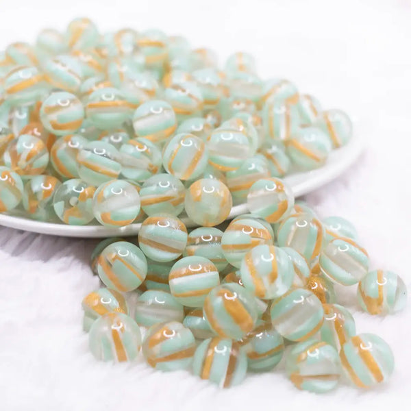 front view of a pile of 12mm Mint Green Cats Eye Acrylic Bubblegum Beads - 20 Count