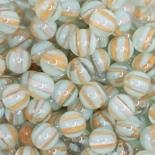 close up view of a pile of 12mm Mint Green Cats Eye Acrylic Bubblegum Beads - 20 Count