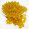 front view of a pile of 12mm Mustard Jelly Acrylic Bubblegum Beads - 20 Count