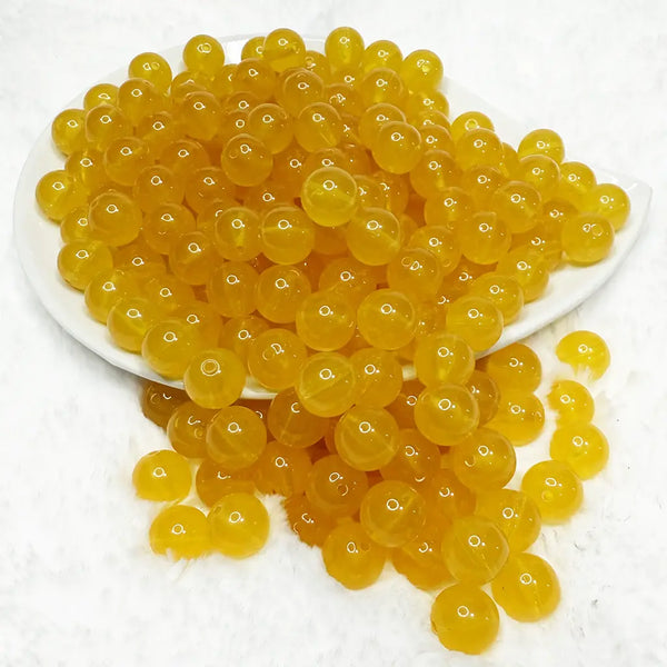 front view of a pile of 12mm Mustard Jelly Acrylic Bubblegum Beads - 20 Count