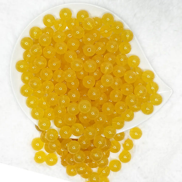 top view of a pile of 12mm Mustard Jelly Acrylic Bubblegum Beads - 20 Count