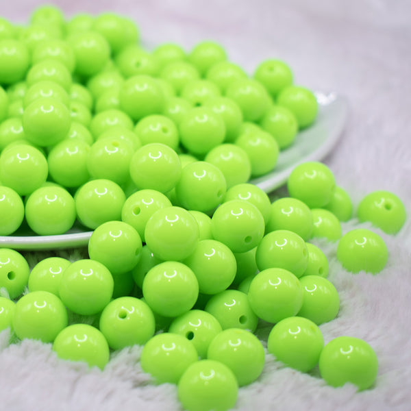 front view of a pile of 12mm Neon Lime Green Acrylic Bubblegum Beads - 20 & 50 Count