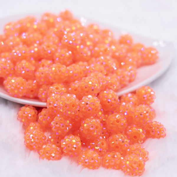 front view of a pile of 12mm Neon Orange Rhinestone AB Bubblegum Beads - 10 & 20 Count