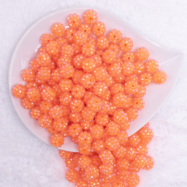 top view of a pile of 12mm Neon Orange Rhinestone AB Bubblegum Beads - 10 & 20 Count