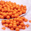 front view of a pile of 12mm Orange Acrylic Bubblegum Beads - 20 & 50 Count