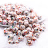 front view of a pile of 12mm Orange and Black Splatter AB Acrylic Bubblegum Beads