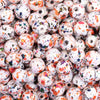 close up view of a pile of 12mm Orange and Black Splatter AB Acrylic Bubblegum Beads