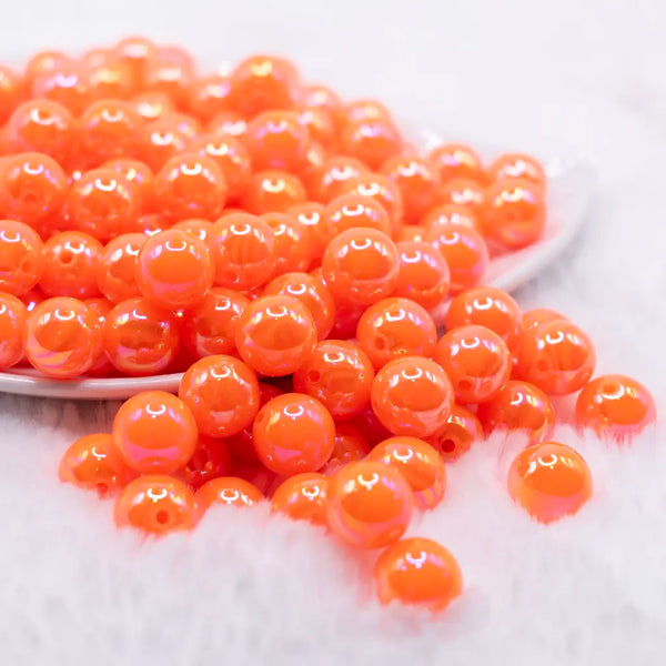 front view of a pile of 12mm Orange Neon AB Solid Bubblegum Beads