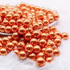front view of a pile of 12mm Orange Pearl Acrylic Bubblegum Beads - 20 Count