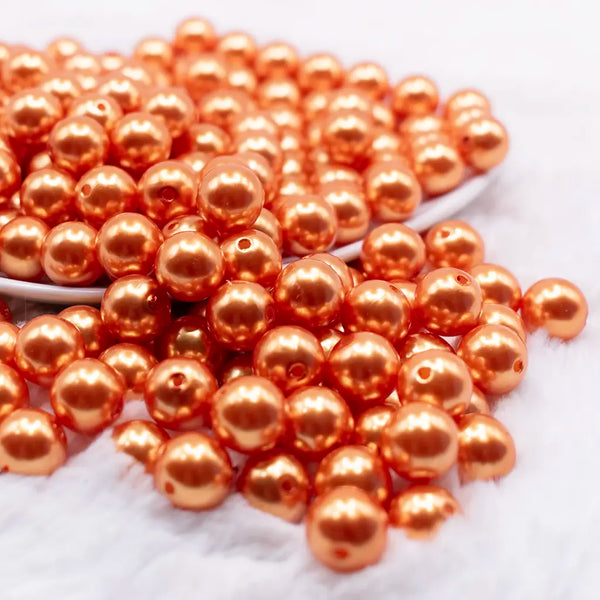 front view of a pile of 12mm Orange Pearl Acrylic Bubblegum Beads - 20 Count