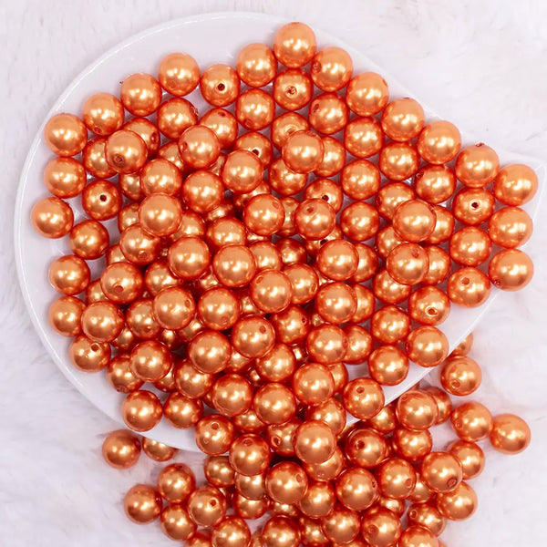 top view of a pile of 12mm Orange Pearl Acrylic Bubblegum Beads - 20 Count
