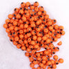 top of a pile of 12mm Orange with Black Spider Print Bubblegum Beads