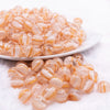 front view ofa pile of 12mm Peach Cats Eye Acrylic Bubblegum Beads - 20 Count