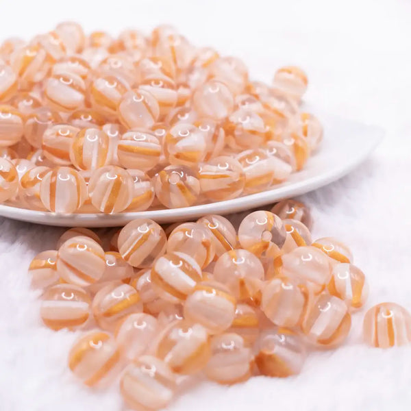 front view ofa pile of 12mm Peach Cats Eye Acrylic Bubblegum Beads - 20 Count