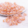 front view of a pile of 12mm Pink Cats Eye Acrylic Bubblegum Beads - 20 Count