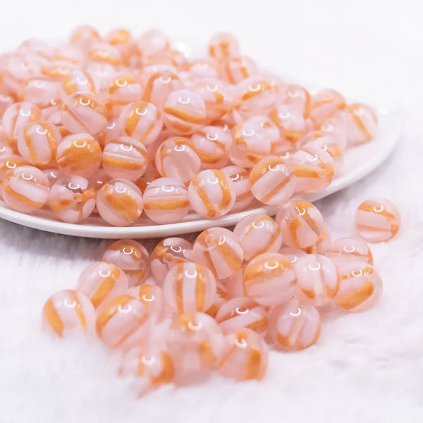 front view of a pile of 12mm Pink Cats Eye Acrylic Bubblegum Beads - 20 Count